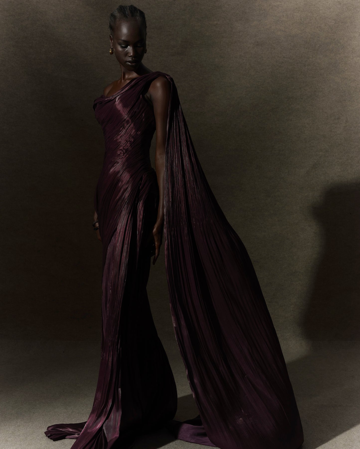 Hand pleated draped Satin-like gown with one shoulder cape